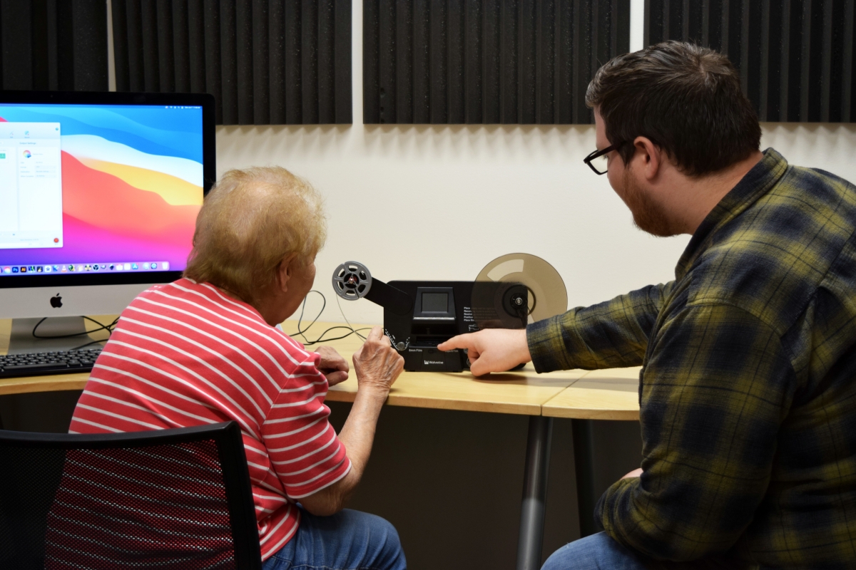 Photo of Rose and Ben working together on the Sound Studio's 8mm converter