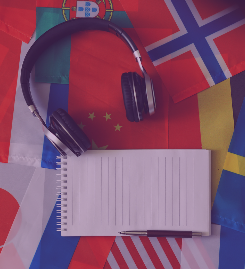 headphones and notepad with international flags