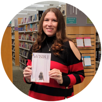 Photo of Laura McPherson holding her book "inVISIBLE."