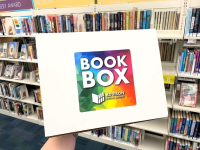 Photo of Book Box. A cardboard box labeled "Book Box" being held up by an unpictured person.