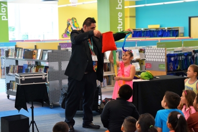 Photo of magician performing in front of children