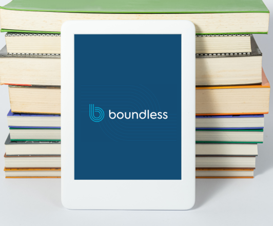 Stock photo. Tablet resting against a stack of books displaying the Boundless logo.