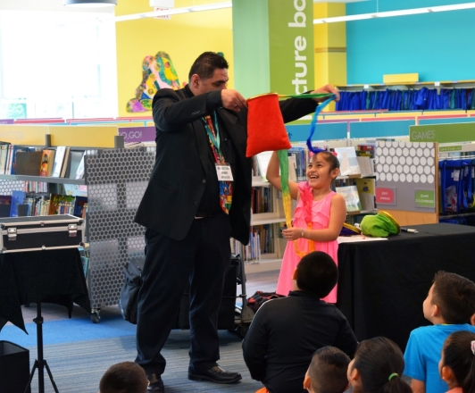 Photo of magician performing in front of children