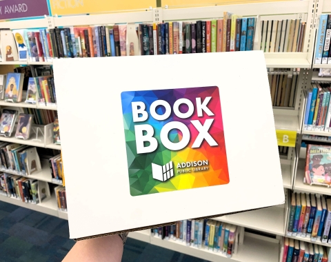 Photo of Book Box. A cardboard box labeled "Book Box" being held up by an unpictured person.