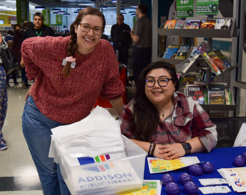 two people behind a table smiling